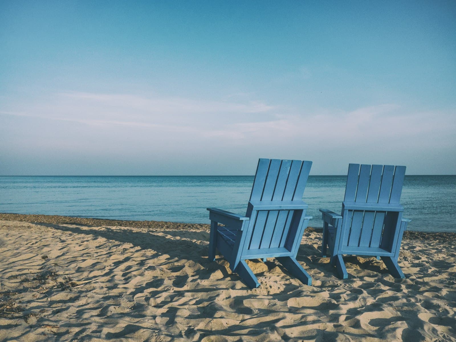 Seaside chairs set for a private beach celebration