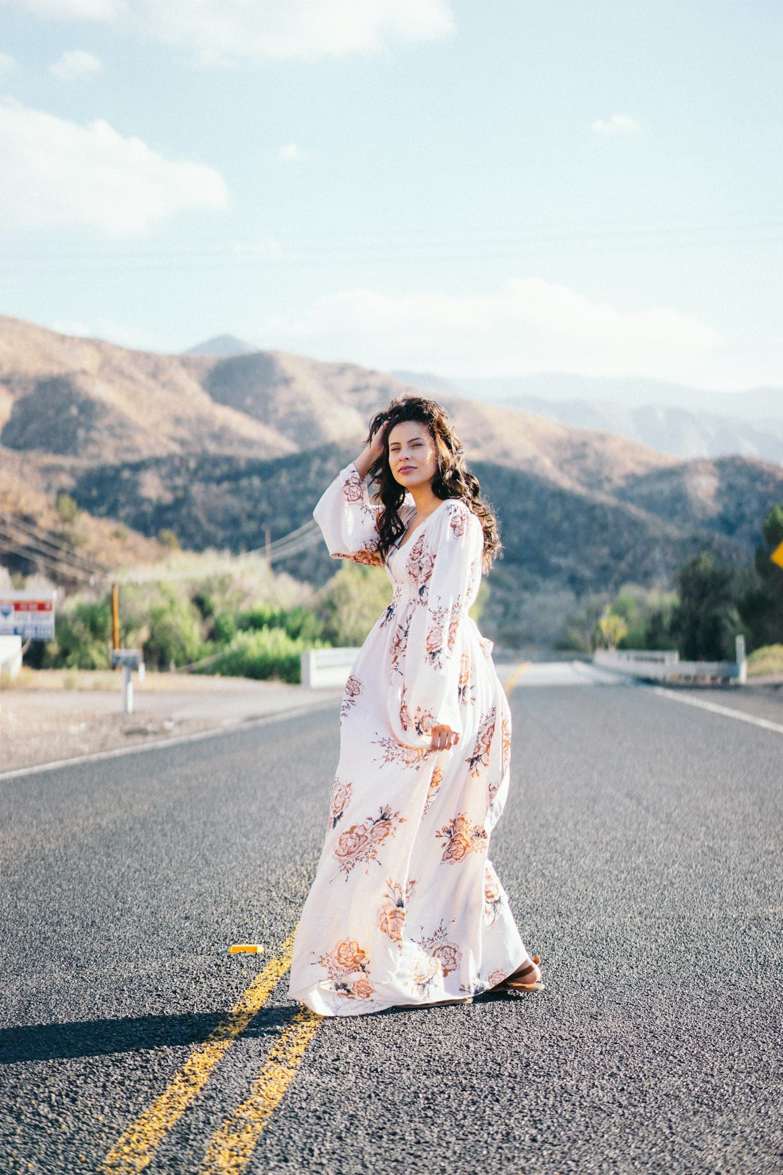 Mother-to-be in a floral gown at golden hour