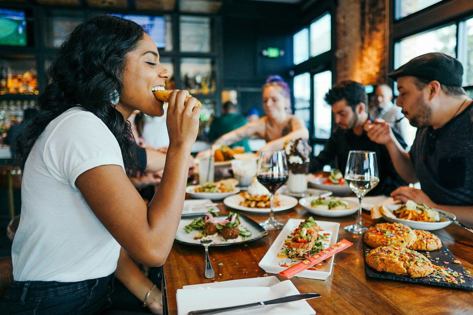 Friends laughing over a festive dinner together