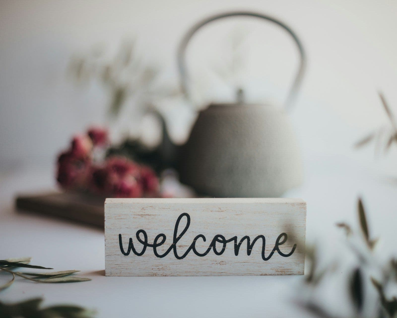 Hand-lettered welcome sign styled with dried florals